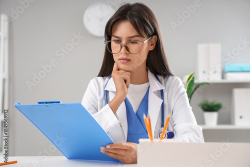 Thoughtful female doctor wi...