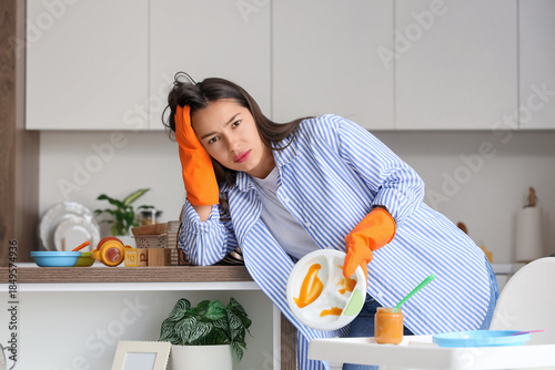 Tired mother with dirty dis...