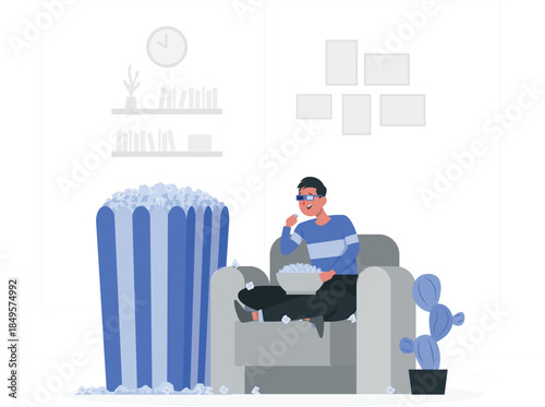 Man wearing 3d glasses sitting on couch eating popcorn next to giant bucket des