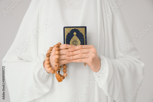 Muslim woman holding Koran ...