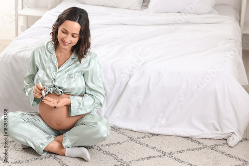 Young pregnant woman using ...