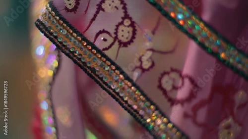 Macro of sari silk threads moving on a loom, shimmering fibers catching light, gold embroidery glinting, hyper detail, rhythmic and graceful.