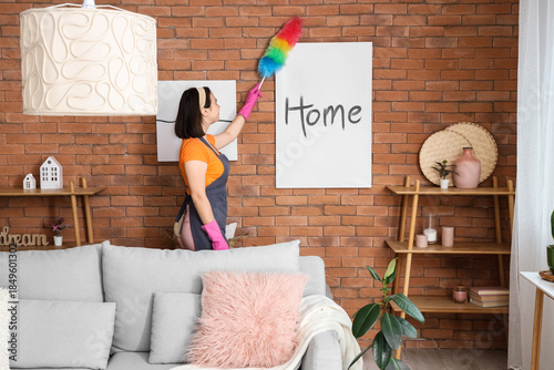 Young woman cleaning poster...