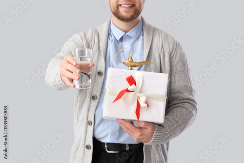Young Muslim man with glass...