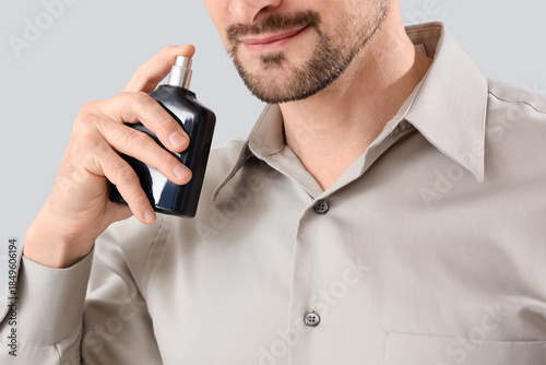 Handsome man with perfume o...
