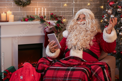 Santa Claus with tablet com...