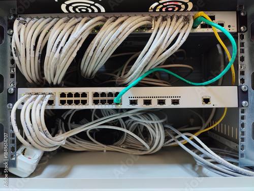 Close-up of Organized Network Switches and Patch Panels with White and Colored Ethernet Cables in a Corporate Data Center Server Rack