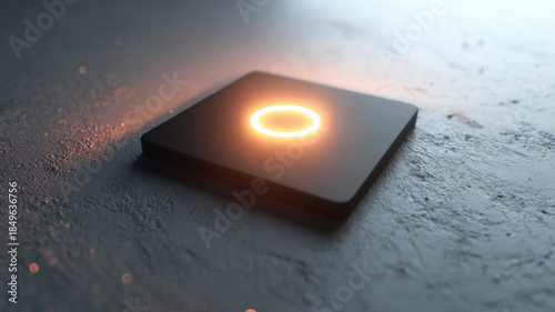 A glowing orange light on a black square surface