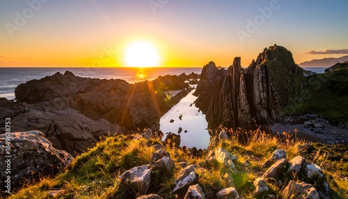 Scenic coastal landscape at sunset, golden sunlight reflecting on water