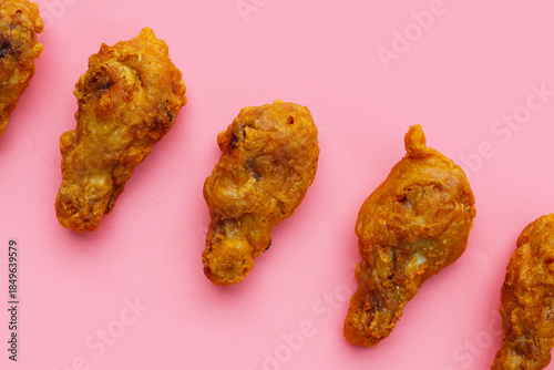 Fried chicken on pink background.