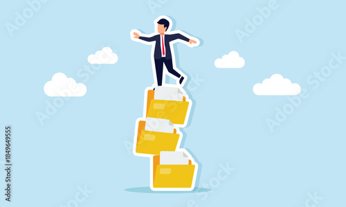 Businessman struggling on a stack of document folders illustrating poor file management and lack of effective and efficient workflow