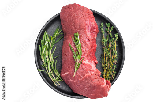 Fotografija Raw beef meat cut with herbs in pan and copy space