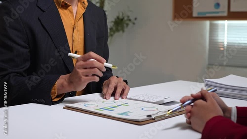Business people discussing financial charts at a meeting