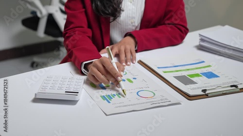 Businesswoman analyzing financial charts and data