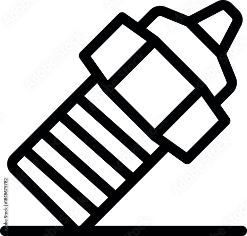 Close up of a car spark plug resting on a surface, emphasizing its role in the automotive ignition system