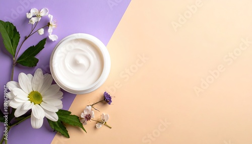 Skincare product and flowers on purple and peach backdrop