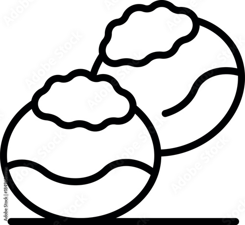 Two delicious brigadeiros, traditional brazilian chocolate sweets covered in chocolate sprinkles, are placed on a surface, ready to be enjoyed