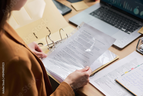 Konstfotografi Young adult woman holding document in transparent sheet protector, reviewing pap