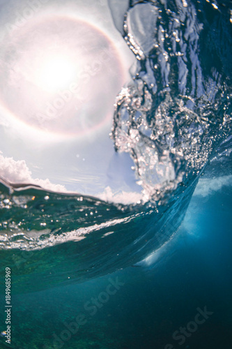 Sunlit Ocean Wave with Lens Flare and Crystal Water