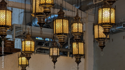 Traditional decorative lanterns hanging outdoors, warm light and cultural atmosphere.