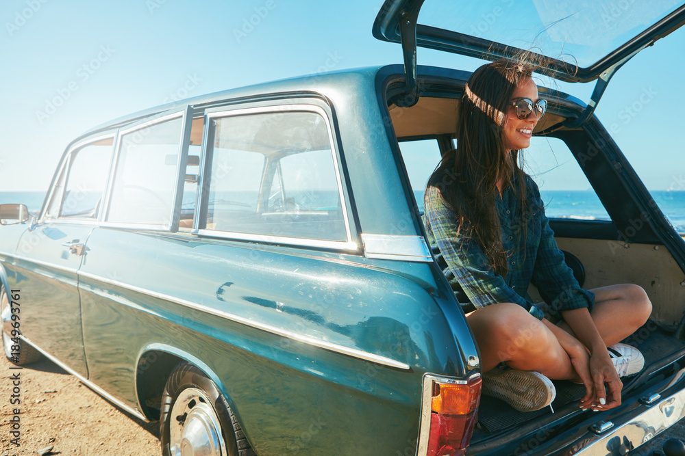 Naklejka premium Car, trunk and woman with road trip at beach for travel adventure, journey pause and sightseeing. Sunglasses, happy girl and relax in vehicle for weekend getaway, explore or fresh air with ocean view