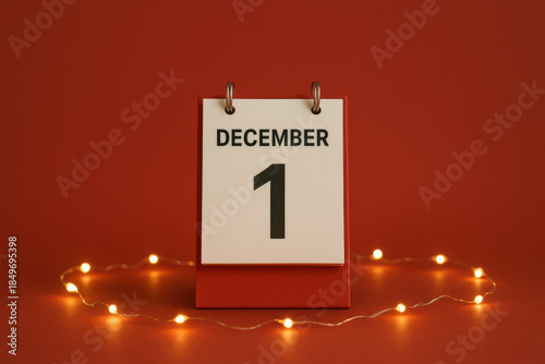 Festive holiday countdown with December calendar date glowing softly. minimal flip calendar sits on clean red background, circled by warm light creating calm mood