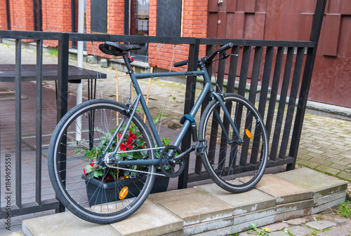 Gray bicycle somewhere in old town. Quite neat landscape with old bicycle.