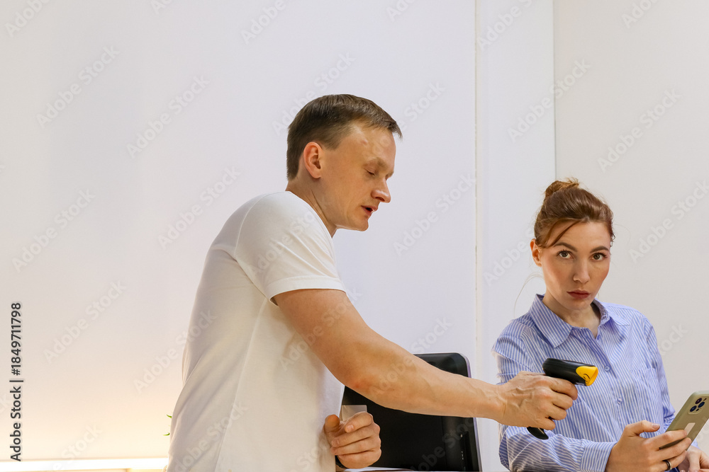 Fototapeta premium Man extending arm with phone for woman to scan