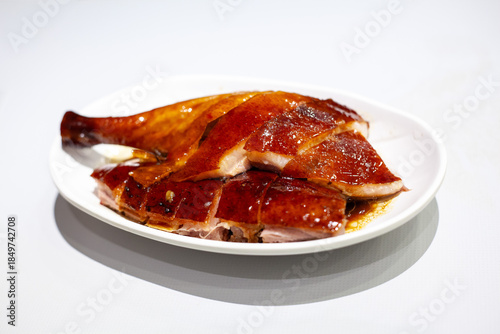 Hong Kong Cantonese style roast goose drumstick on white background