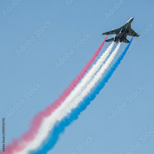 Skyborne Symphony: An agile fighter jet streaks across the cerulean expanse, leaving a trail of vibrant vapor in its wake, creating a dynamic dance in the sky.