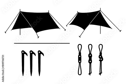 Camping equipment setup: tarps, stakes, ropes, and poles.