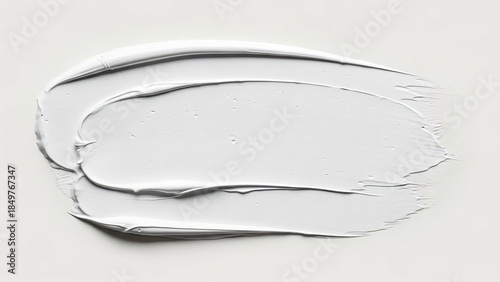 White paint smear on flat surface. Abstract brush stroke texture. Cosmetic cream or gel background for beauty product promotion. Cloud Dancer Color of the Year 2026