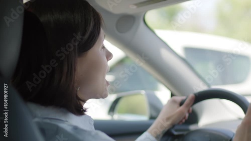 Woman Driving and Singing Along to Music. Joyful Car Ride