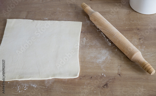 rolling pin and flour on wooden background.