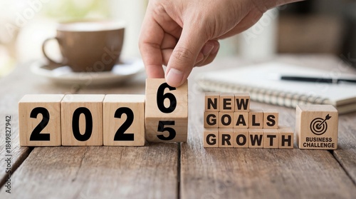 Hand changing 2025 to 2026 on wooden cubes
