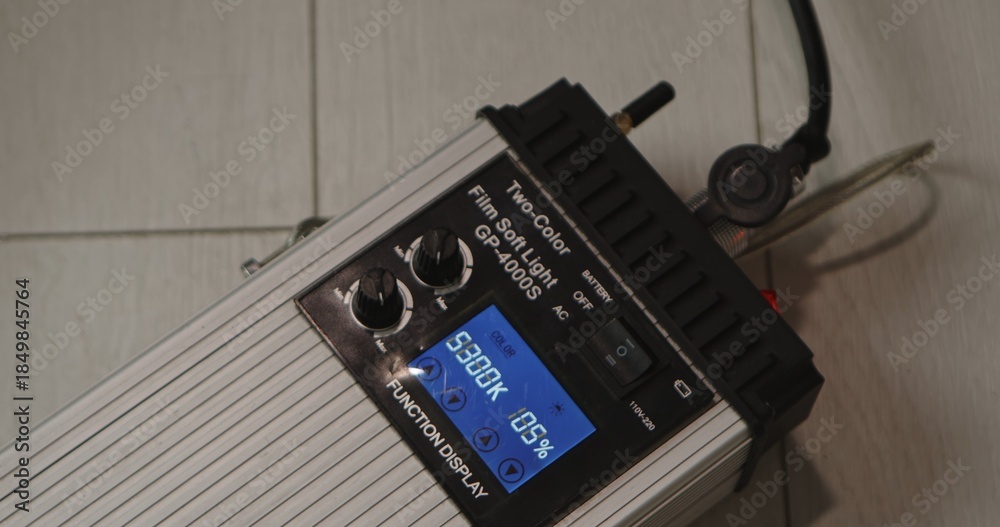 Fototapeta premium Studio LED light controller with screen showing color temperature and brightness settings