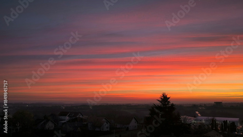 colorful sky at sunrise with aircraft trails in December above Petrovaradin