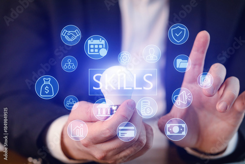 Man holds a light bulb and interacts with skill icons in a business setting