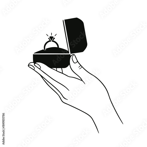 A hand holding an open jewelry box with a diamond ring inside on
