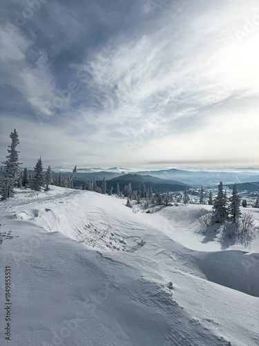Mountain view with snowy slopes and distant ranges