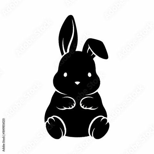 Cute black bunny rabbit sitting with big ears.