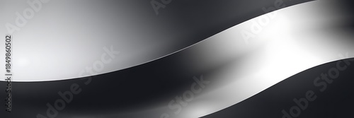 Abstract flowing ribbon or wave design in monochrome gray tones, creating a dynamic and modern background for graphics.