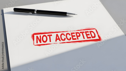 Rejected document with NOT ACCEPTED stamp and pen on white paper