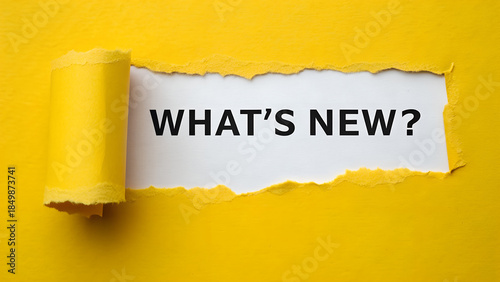 Картината върху платно Torn yellow paper revealing the text whats new question on a white background fo