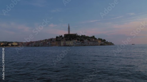 Wallpaper Mural Boat view of Rovinj old town skyline and church tower at dusk on the Adriatic Sea, Croatia. Calm water and pastel twilight sky create a serene mood. Torontodigital.ca