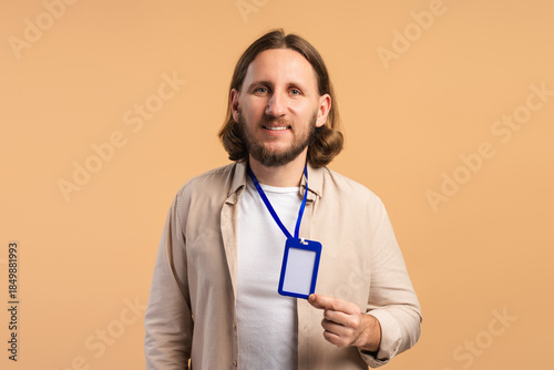 Billede på lærred Happy man holding an empty ID card on a lanyard, ready for conference access