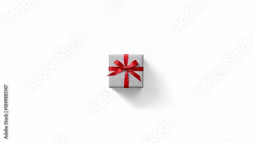 Minimalist gray gift box with red ribbon bow. Elegant present isolated on white background.