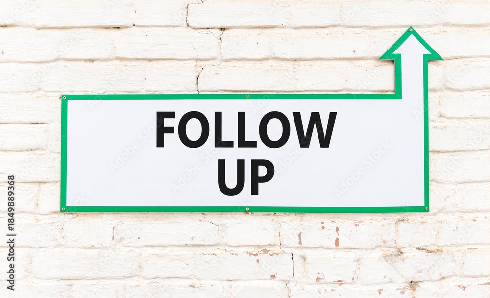 Obraz premium Follow up symbol. Concept word Follow up on beautiful white sign on white brick wall. Beautiful white brick wall background. Business follow up concept. Copy space.
