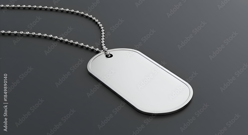 Fototapeta premium Military dog tag with chain on dark background. Blank identification tag hanging from chain, displaying a clean, minimalist design.