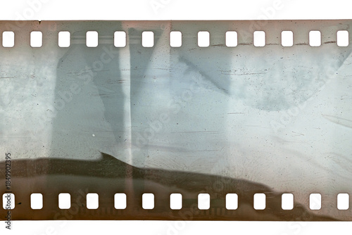 Dusty and grungy 35mm film texture or surface. Perforated scratched camera film isolated on white background.